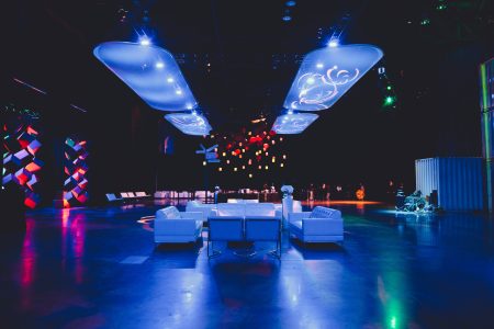 work-holiday-party-in-warehouse-white-lounge-furniture-and-colorful-lighting