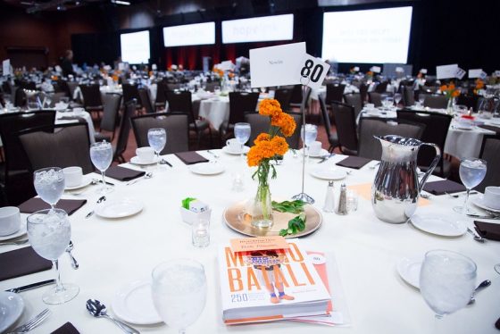 Seattle-Corporate-event-planning-lunch-in-venue-with-orange-flowers-white-linen