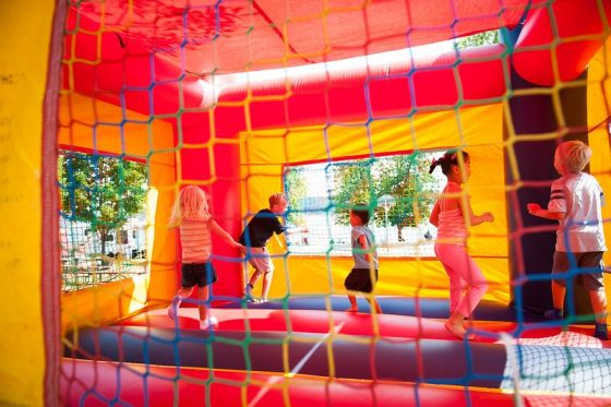 kids jumping in colorful bounce house